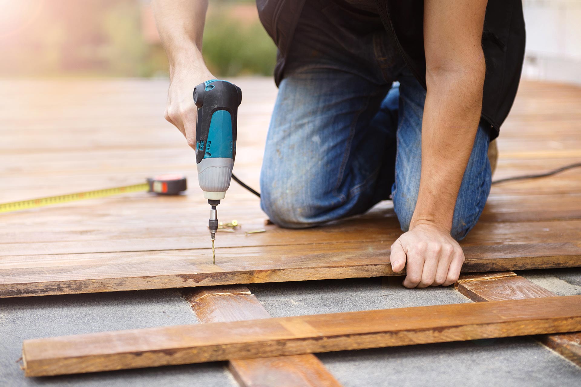 handyman installing wooden flooring